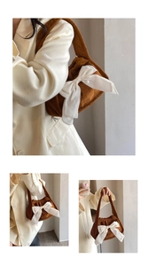 Close-up of brown corduroy handbag featuring a large white silk bow with model wearing beige suit
