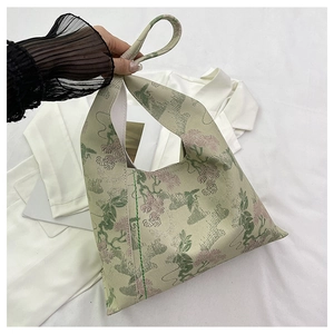 Detailed close-up of Neo-Chinese jacquard fabric bucket bag with floral embroidery detail