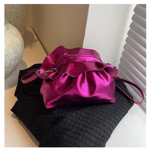 Detail of purple metallic cloud bag with gathered folds and matching strap on fabric