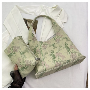 Detail of light green floral jacquard tote bag and matching pouch with fine embroidery