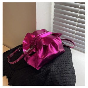 Detail of metallic magenta cloud bag with drawstring pleats and glossy PU finish