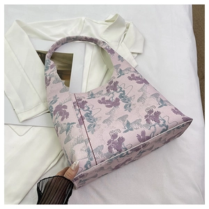 Detail of floral jacquard fabric on the pink bucket bag with elegant pine embroidery