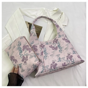 Detail of two-piece floral jacquard tote and matching zipper pouch set in pink