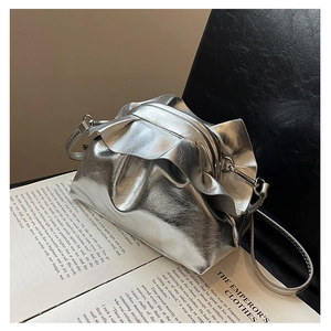 Detail of silver metallic cloud bag with gathered ruffles and mirror-like reflection texture