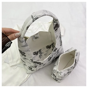Detail of artistic floral print tote bag with inner pouch and silver magnetic closure