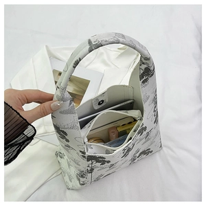 Top view of white bucket bag with floral embroidery showing spacious interior and pockets