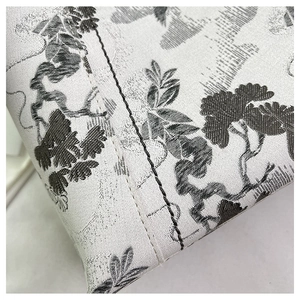 Detail shot of vintage Toile de Jouy fabric and precise stitching on a shoulder bag