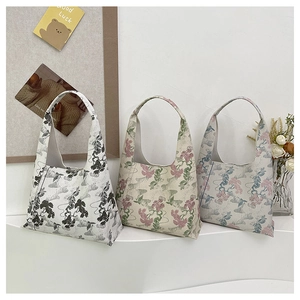 Detailed embroidery of vintage floral and pine patterns on large shoulder bucket bags