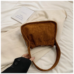 Detailed close-up of brown corduroy tote bag with white drawstring and soft texture