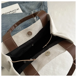 Top view of canvas bucket bag interior featuring magnetic closure and a zip pocket