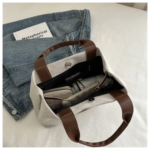 Detail view of canvas bucket bag interior with magnetic closure and large capacity
