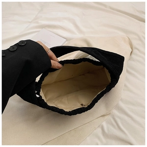 Internal view of black corduroy tote bag showing spacious lining and zipper pocket