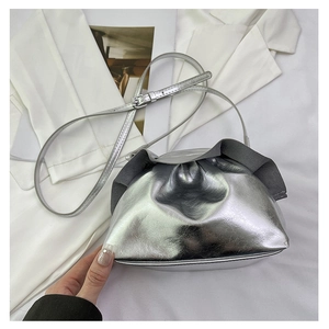 Detail of silver metallic crossbody bag with stylish pleated drawstring and shoulder strap
