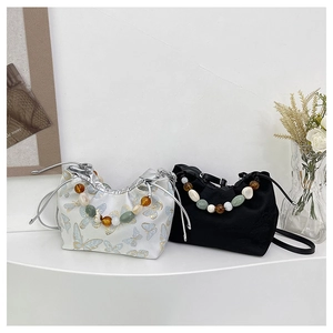 Détail de sacs à cordon avec poignées en perles colorées et motif de papillon élégant