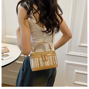 Detail of the woven texture and brown leather trim on the contrast box bag for women