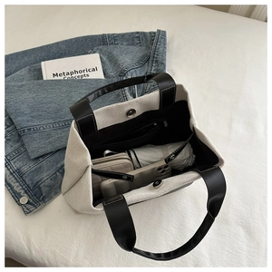 Interior view showing large capacity with magnetic snap on this canvas bucket bag
