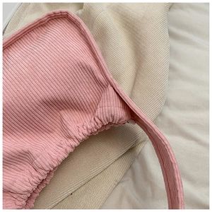 Close-up of pink corduroy handbag detail showing soft ribbed fabric and quality stitching