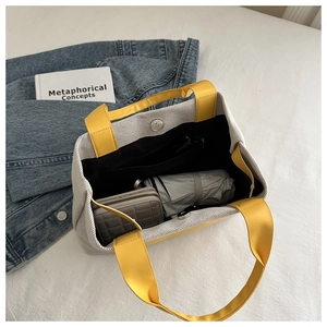 Interior view of grey woven tote bag showing magnetic closure and spacious compartment