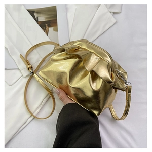 Detail of golden metallic leather ruched cloud bag with drawstring details and strap