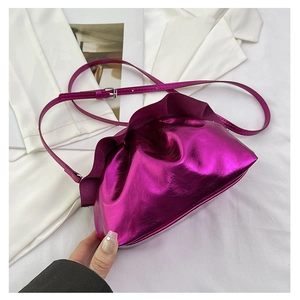 Detail of fuchsia metallic cloud pouch bag with ruched texture and adjustable strap