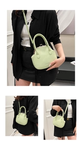 Close-up of mint green PU leather bag featuring vintage kiss-lock and hand-held details