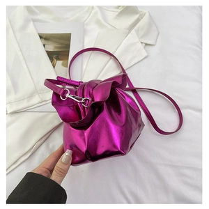 Detail of metallic purple gathered cloud bag with silver clasp and slim shoulder strap