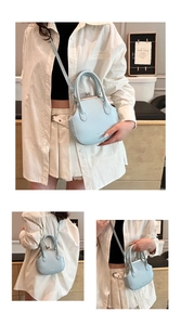 Macro view of light blue kiss-lock crossbody bag with matte finish and top handle