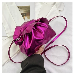 Detail shot of a candy pink metallic ruched cloud bag with silver hardware and thin strap