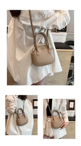 Detail of retro beige kiss-lock doctor bag in matte PU leather with crossbody strap