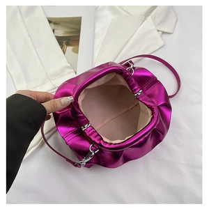 Top view of metallic purple cloud bag with magnetic closure and beige fabric lining