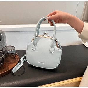 Light blue vintage doctor bag with top handle and adjustable shoulder strap detail