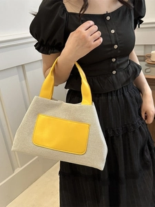Canvas and yellow leather patchwork bucket tote bag for women with minimalist styling