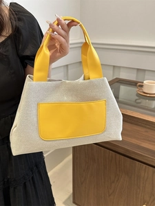Chic yellow and beige canvas bucket bag for women, stylish tote with leather accents