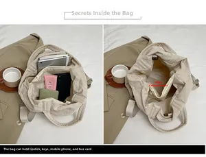 Détail de l'intérieur du grand sac fourre-tout en nylon beige montrant les compartiments organisés