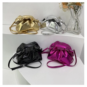 Detailed view of cloud pouch bags in metallic gold, silver, pink, and black finishes
