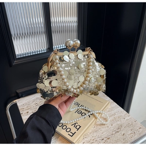 Detailed view of luxury gold sequin evening clutch bag with double pearl clasp and chain