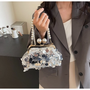 Detail of silver sequin evening bag featuring large pearl clasp and double pearl handle