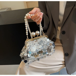 Detail of silver sequin evening bag with pearl handle and vintage metal clasp closure