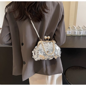 Detail of silver sequin evening bag with dual pearl chain straps and vintage clasp