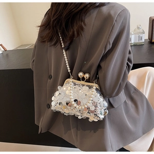 Detail of silver sequin evening bag with pearl chain strap and vintage clasp closure