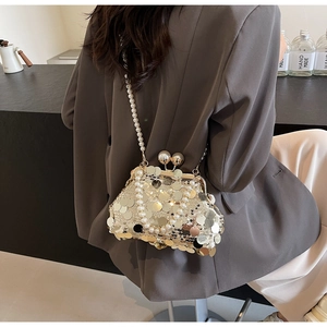 Detail of luxury sequin evening bag with champagne gold discs and pearl strap