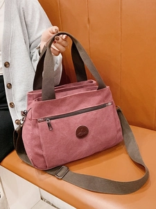 Borsa a mano vintage in tela rosa con scomparti multipli e tracolla marrone scuro
