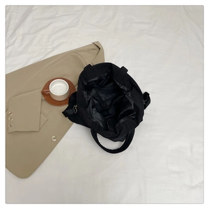 Détail de l'intérieur d'un grand sac cabas noir avec poches fonctionnelles et compartiments