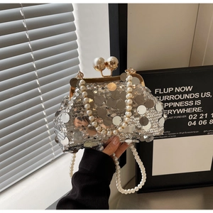 Detail of silver sequin evening clutch with pearl clasp and double pearl chains