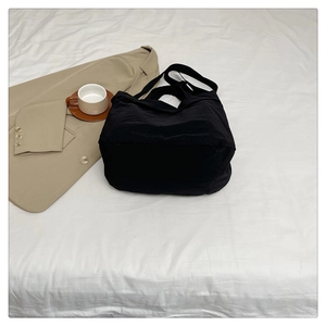 Détail du grand sac fourre-tout noir en nylon avec bandoulière large et style décontracté