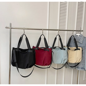 Detail view of large canvas tote bags in four colors with adjustable shoulder straps