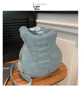 Detail view of a creative guitar-shaped crossbody bag in light blue with silver metal studs