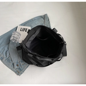 Top view of large black tote bag showing spacious interior and adjustable shoulder strap