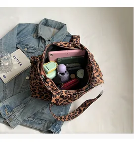 Macro view of leopard print tote bag interior showing large capacity for essentials