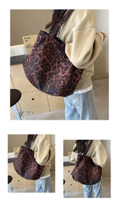 Detailed close-up of large leopard print tote bag with thick canvas texture and shoulder straps